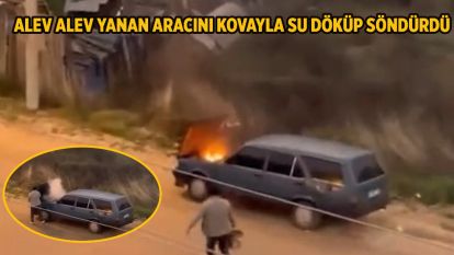 Alev alev yanan aracını kovayla su döküp söndürdü