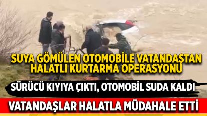 Sürücü kıyıya çıktı, otomobil suda kaldı: Vatandaşlar halatla müdahale etti